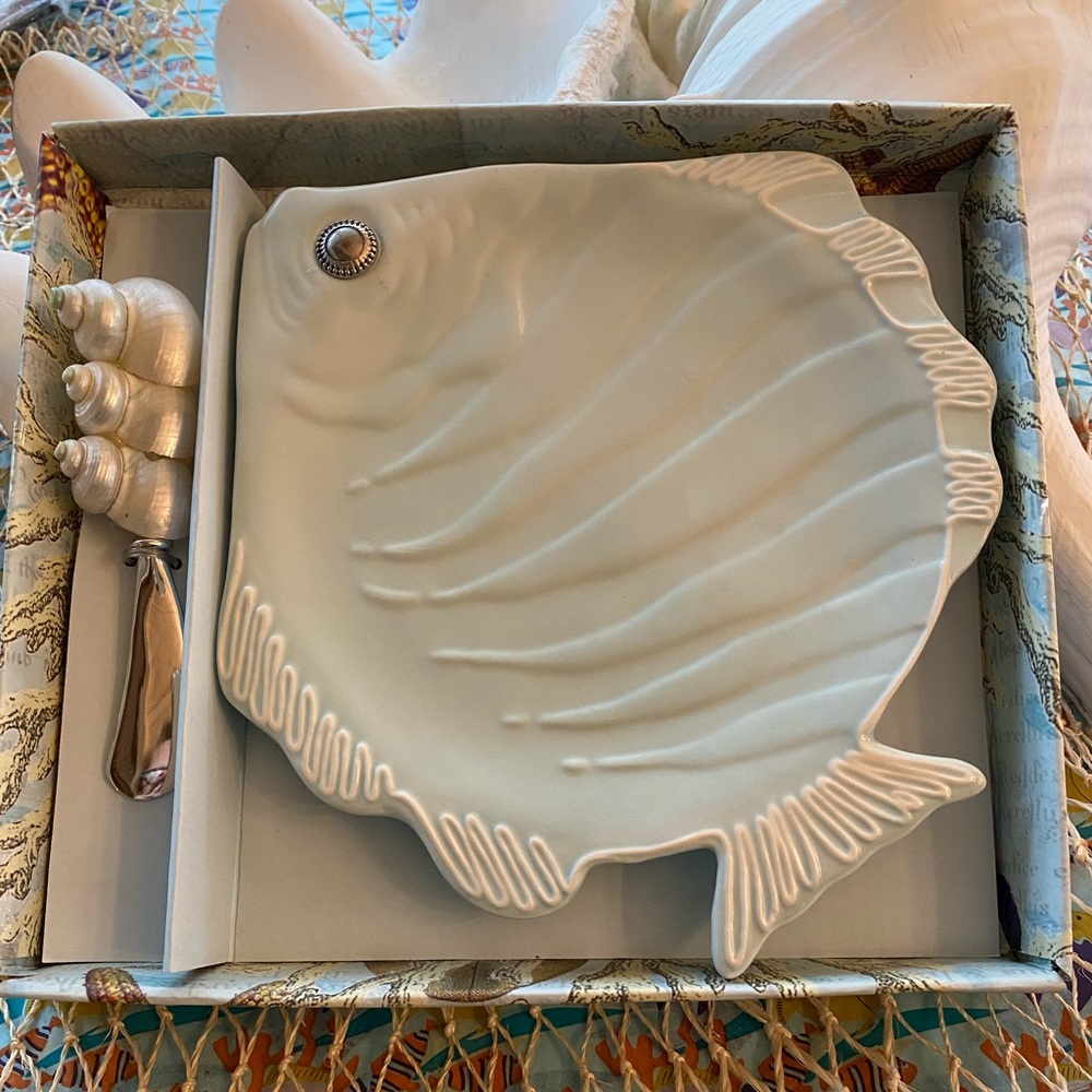 Fish platter with shell Handel cheese spreader.